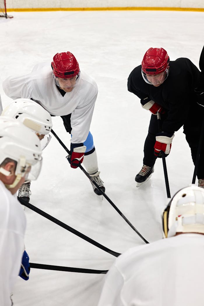 Ice hockey players in a team huddle, preparing for the game on the rink.