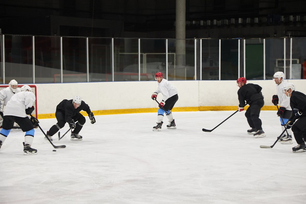 Ice hockey team training on the ice rink, showcasing skill and teamwork in a sports stadium.